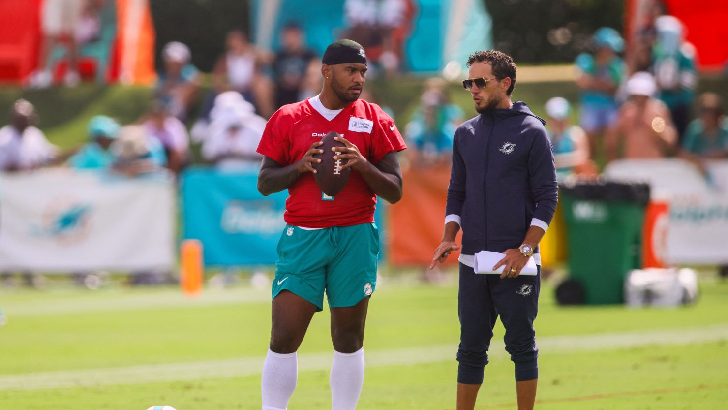 Jul 28, 2024; Miami Gardens, FL, USA; Miami Dolphins quarterback Tua Tagovailoa (1) talks to head coach Mike McDaniel during training camp at Baptist Health Training Complex. Mandatory Credit: Sam Navarro-USA TODAY Sports