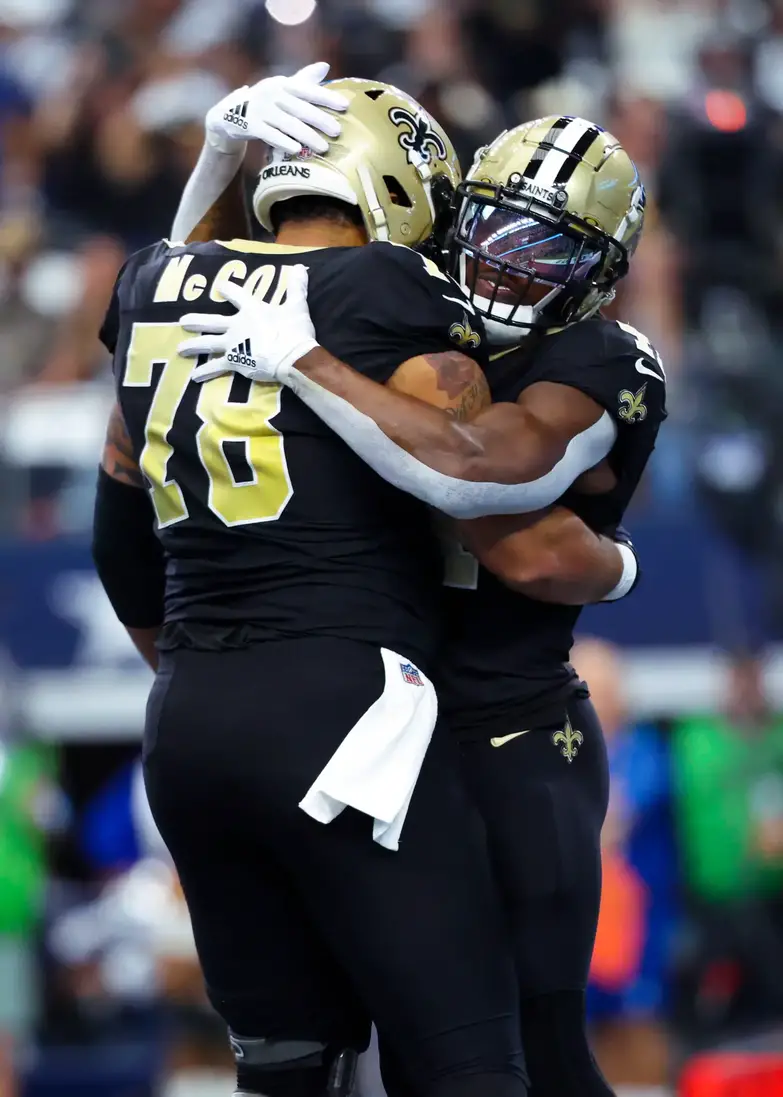 Sep 15, 2024; Arlington, Texas, USA; New Orleans Saints running back Alvin Kamara (41) celebrates with New Orleans Saints center Erik McCoy (78) after scoring a touchdown during the first quarter against the Dallas Cowboys at AT&T Stadium. Mandatory Credit: Kevin Jairaj-Imagn Images